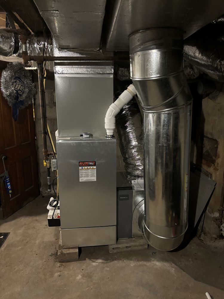 High-efficiency Trane RunTru gas furnace installation with sheet metal trunk line